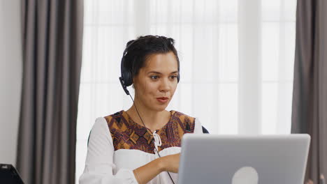Excited-woman-with-headphones-during-a-video-call