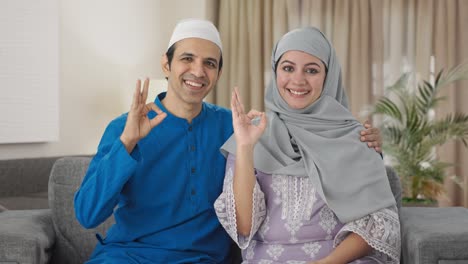Happy-Muslim-couple-showing-okay-sign
