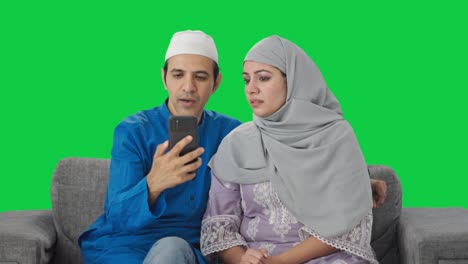 Muslim-couple-talking-their-child-on-video-call-Green-screen