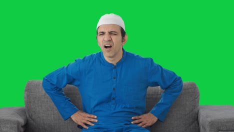 Sick-Muslim-man-suffering-stomach-pain-Green-screen