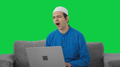 Sleepy-and-lazy-Muslim-man-using-laptop-Green-screen