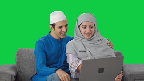 Muslim-couple-doing-online-shopping-on-laptop-Green-screen