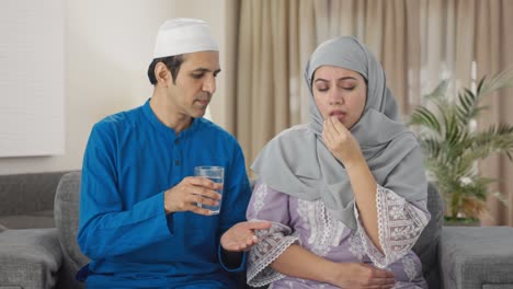 Muslim-husband-giving-medicine-to-his-wife