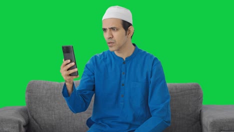 Angry-Muslim-man-talking-on-video-call-Green-screen