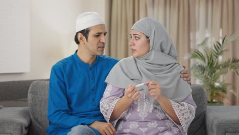 Stressed-Muslim-couple-checking-pregnancy-test