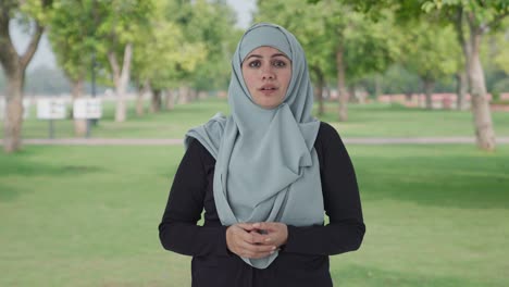 Ernsthafte-Muslimische-Frau,-Die-Im-Park-Mit-Der-Kamera-Spricht