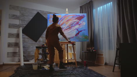 Artist-looking-at-painting