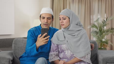 Muslim-couple-talking-their-child-on-video-call