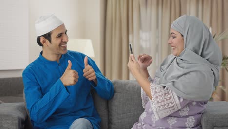 Glückliche-Muslimische-Frau,-Die-Auf-Bilder-Ihres-Mannes-Klickt