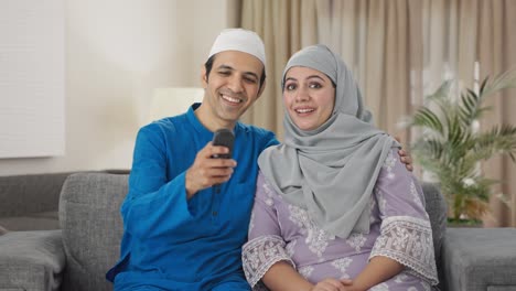 Happy-Muslim-couple-watching-TV