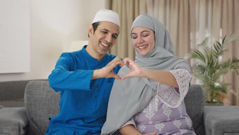 Happy-Muslim-couple-making-heart-sign