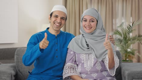 Happy-Muslim-couple-showing-thumbs-up