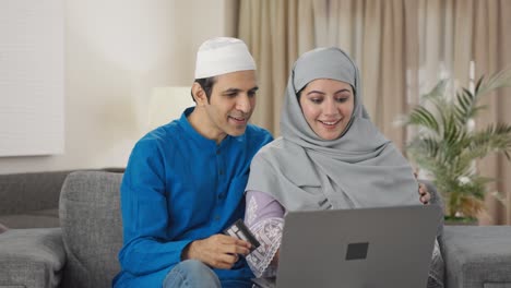 Feliz-Pareja-Musulmana-Haciendo-Compras-En-Línea-En-Una-Computadora-Portátil-Con-Tarjeta-De-Crédito