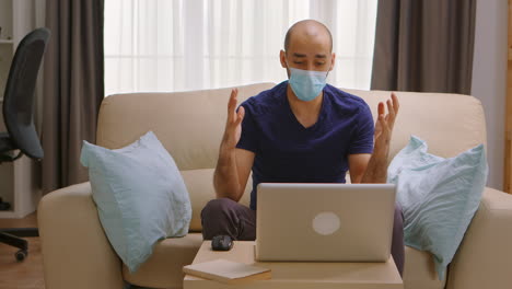 Man-with-protection-mask-on-a-business-video-call