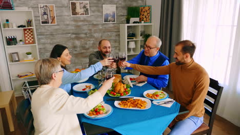 Top-view-of-family-clinking-glasses-with-red-wine