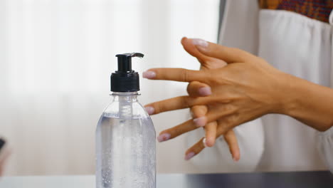 Close-up-of-woman-using-hand-sanitizer