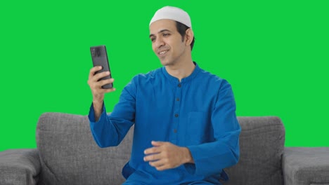 Happy-Muslim-man-talking-on-video-call-Green-screen