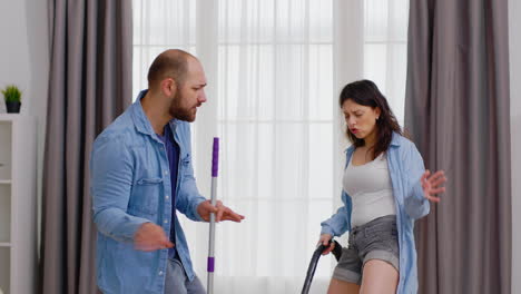 Couple-dancing-while-cleaning