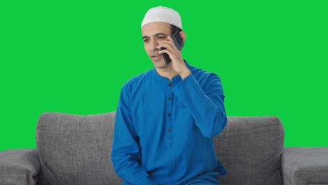 Muslim-man-talking-on-phone-Green-screen