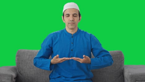 Muslim-man-doing-Yoga-at-home-Green-screen