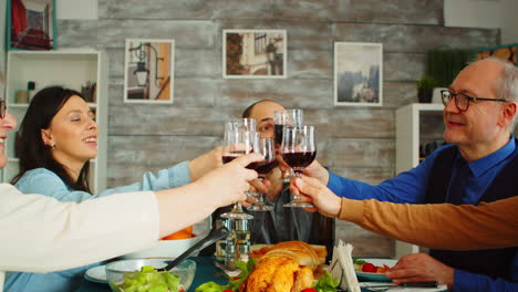 Happy-young-family-toasting-with-wine-glasses