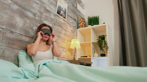 Young-woman-with-pajamas-sleeping-with-mask-over-her-eyes