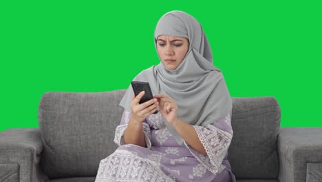 Angry-Muslim-woman-using-mobile-phone-Green-screen