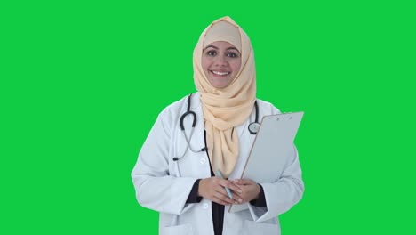 Happy-Muslim-doctor-listening-to-patient-Green-screen