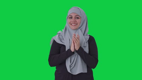Happy-Muslim-woman-clapping-and-appreciating-Green-screen