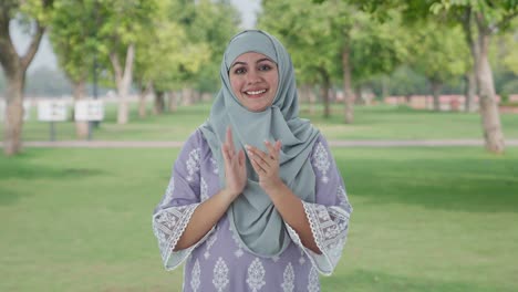 Happy-Muslim-woman-clapping-and-appreciating-in-park