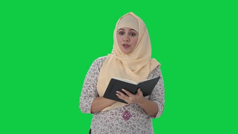 Happy-Muslim-teacher-teaching-in-school-Green-screen
