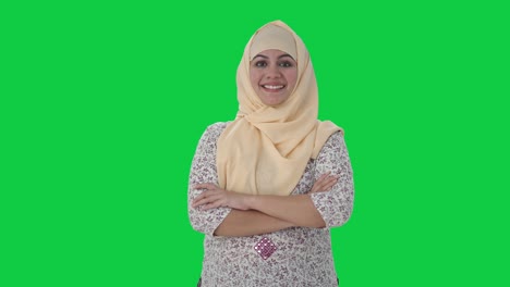 Happy-Muslim-teacher-standing-crossed-hands-Green-screen