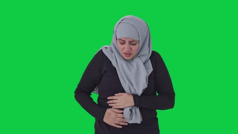 Sick-Muslim-woman-suffering-from-Stomach-pain-Green-screen