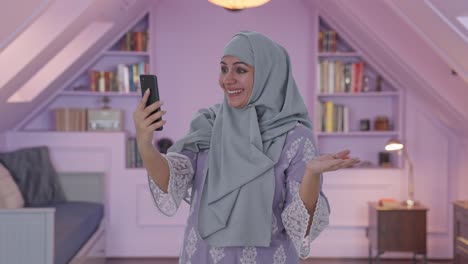 Happy-Muslim-woman-talking-on-video-call