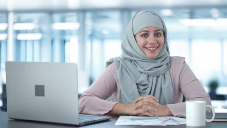 Happy-Muslim-businesswoman-talking-to-camera