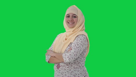 Portrait-of-Happy-Muslim-teacher-standing-crossed-hands-Green-screen