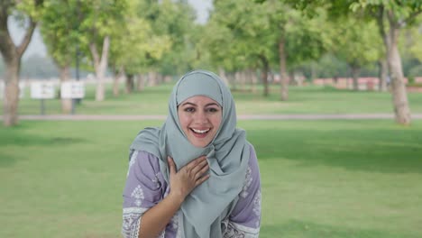Happy-Muslim-woman-laughing-on-someone-in-park