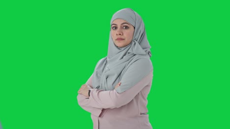 Portrait-of-Happy-Muslim-businesswoman-standing-crossed-hands-Green-screen