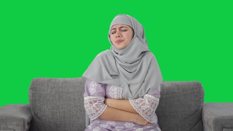 Sick-Muslim-woman-suffering-from-Stomach-pain-Green-screen