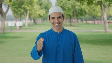 Happy-Muslim-man-doing-Adaab-and-greetings-in-park