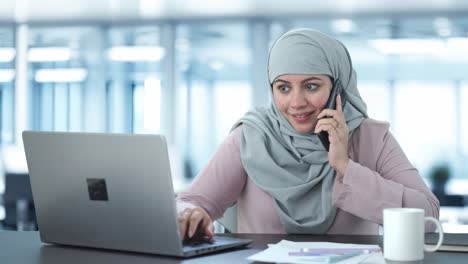 Happy-Muslim-businesswoman-talking-on-phone
