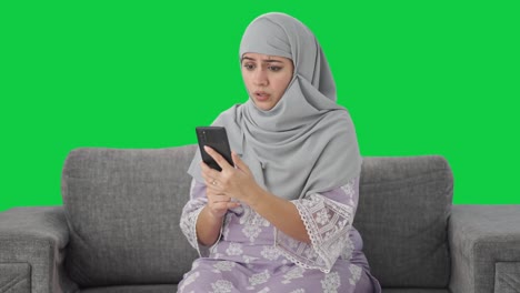 Angry-Muslim-woman-talking-on-video-call-Green-screen