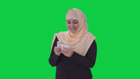 Happy-Muslim-woman-counting-money-Green-screen