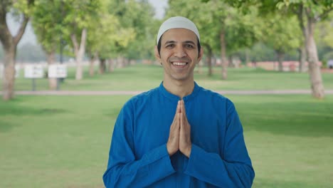 Happy-Muslim-man-doing-Namaste-in-park