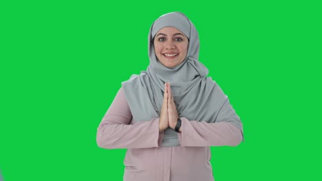 Happy-Muslim-businesswoman-doing-Namaste-Green-screen