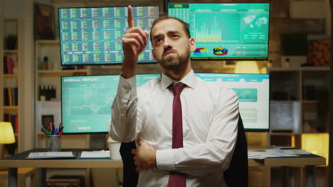 Male-stock-market-broker-pointing-while-using-augmented-reality