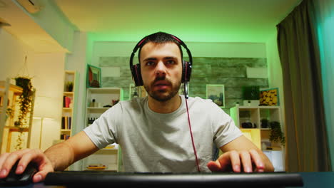 Pov-of-young-man-with-headphones-playing-games