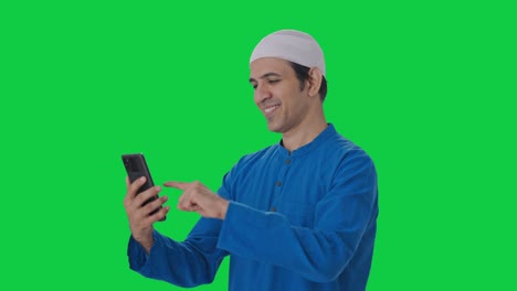 Happy-Muslim-man-using-Phone-Green-screen