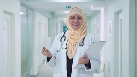 Happy-Muslim-doctor-talking-to-patient