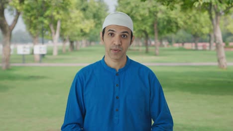 Ernsthafter-Muslimischer-Mann,-Der-Im-Park-Mit-Der-Kamera-Spricht